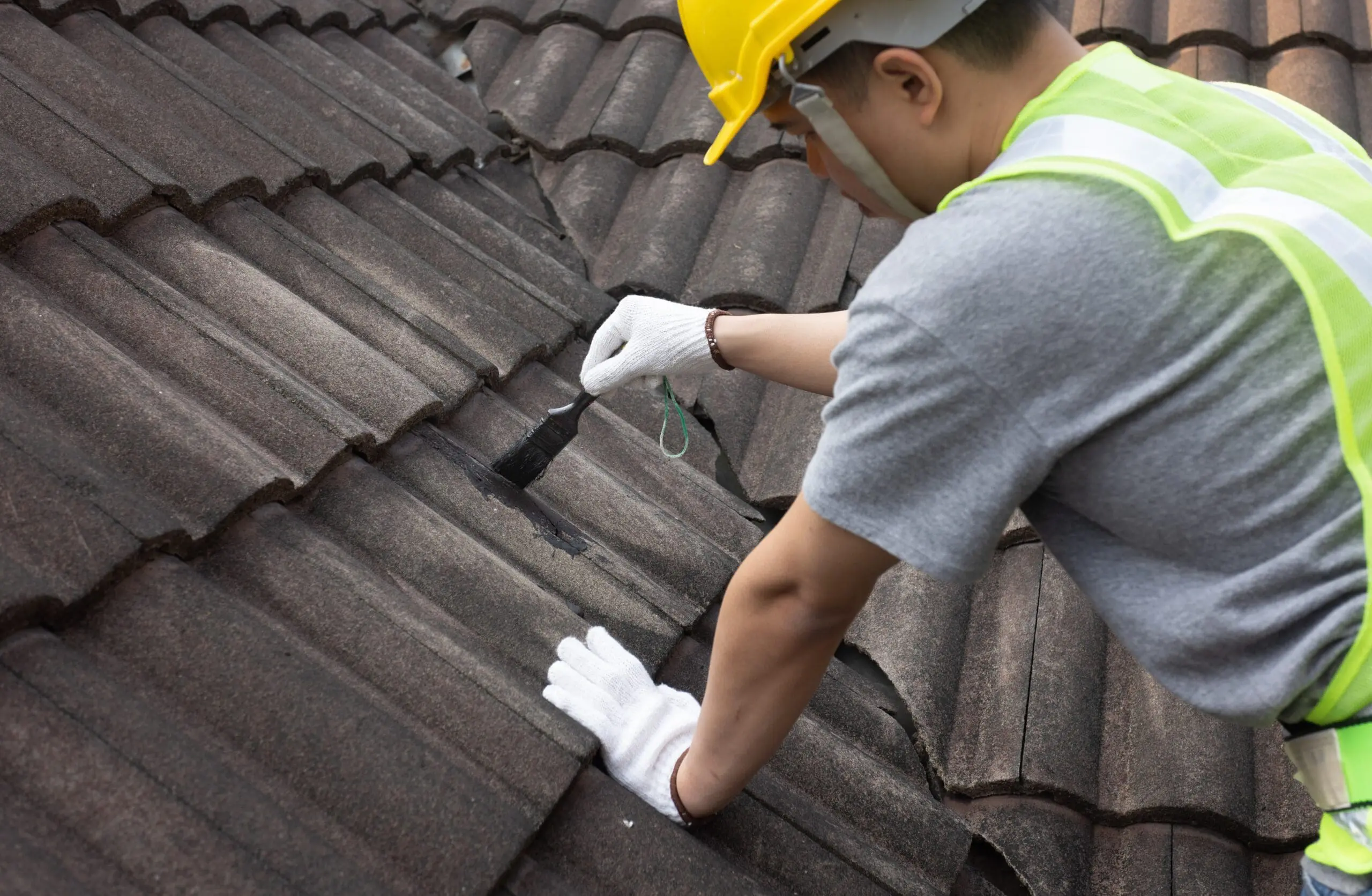 Worker,Man,Using,Waterproof,Roof,Coating,Repair,To,Fix,Crack